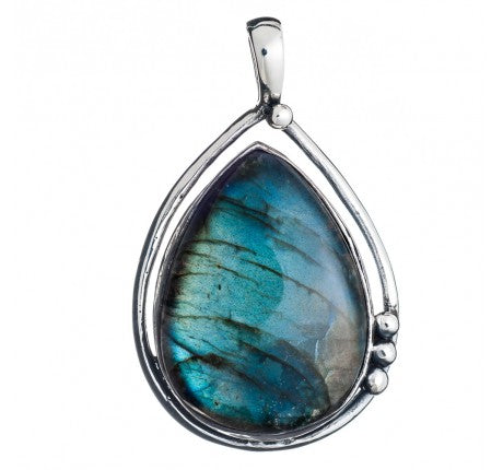 The Poppy Pendant Large in various gemstones by Gallardo & Blaine Designs is a teardrop-shaped piece featuring a mesmerizing labradorite gemstone set in polished sterling silver. The labradorite displays iridescent blue and green hues, while the smooth, clean design of the polished silver frame is accented by three small decorative silver beads on the right side.