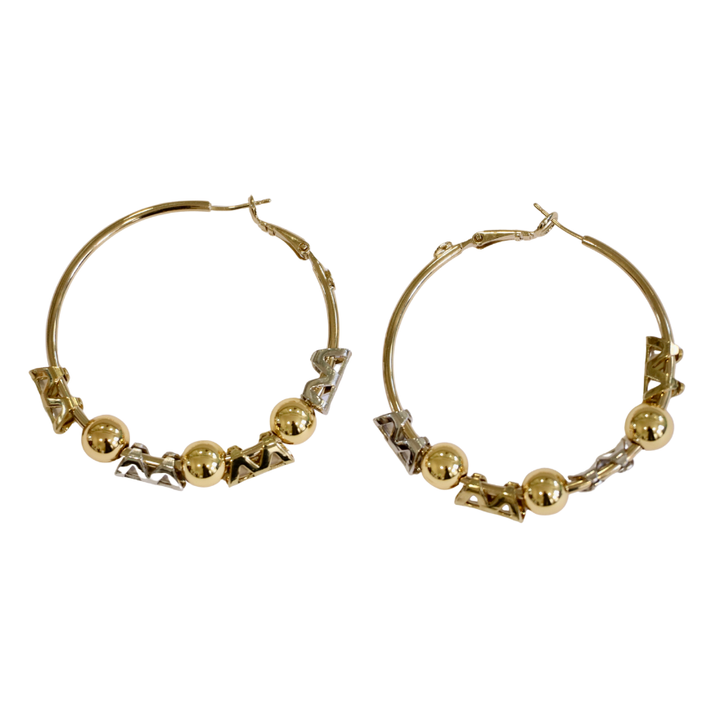 The Zubeldia Gold and Silver Hoop Earrings feature three gold-plated beads and silver zigzag accents along the bottom of each hoop, shown against a white background.