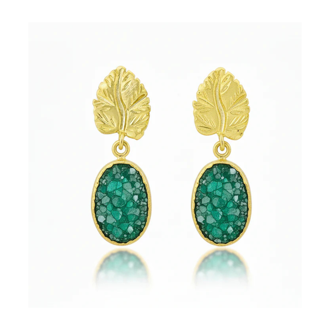 A pair of Green Druzy And Gold Leaf Earrings by Watermelon Tropical. The stones have a textured, crystalline appearance, and the gold metal settings feature detailed leaf designs.
