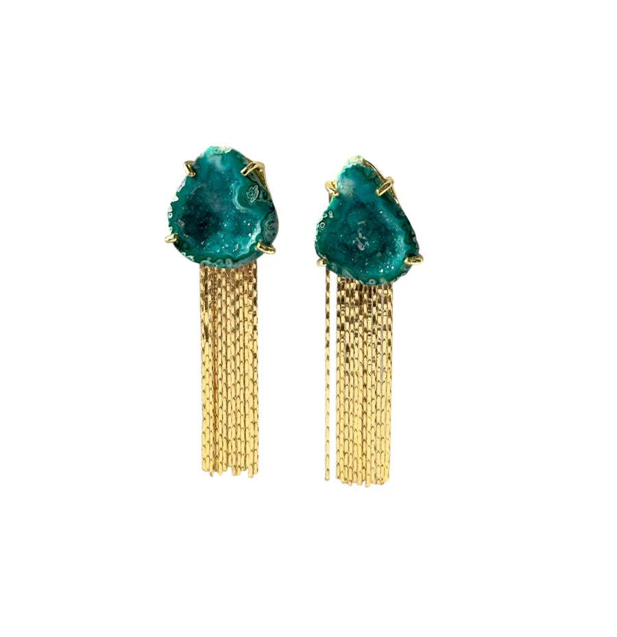 The Aria V Green Geode Tassel Earrings are handmade in Ireland, featuring rough turquoise stones set in gold with cascading gold chain tassels, shown on a white background.