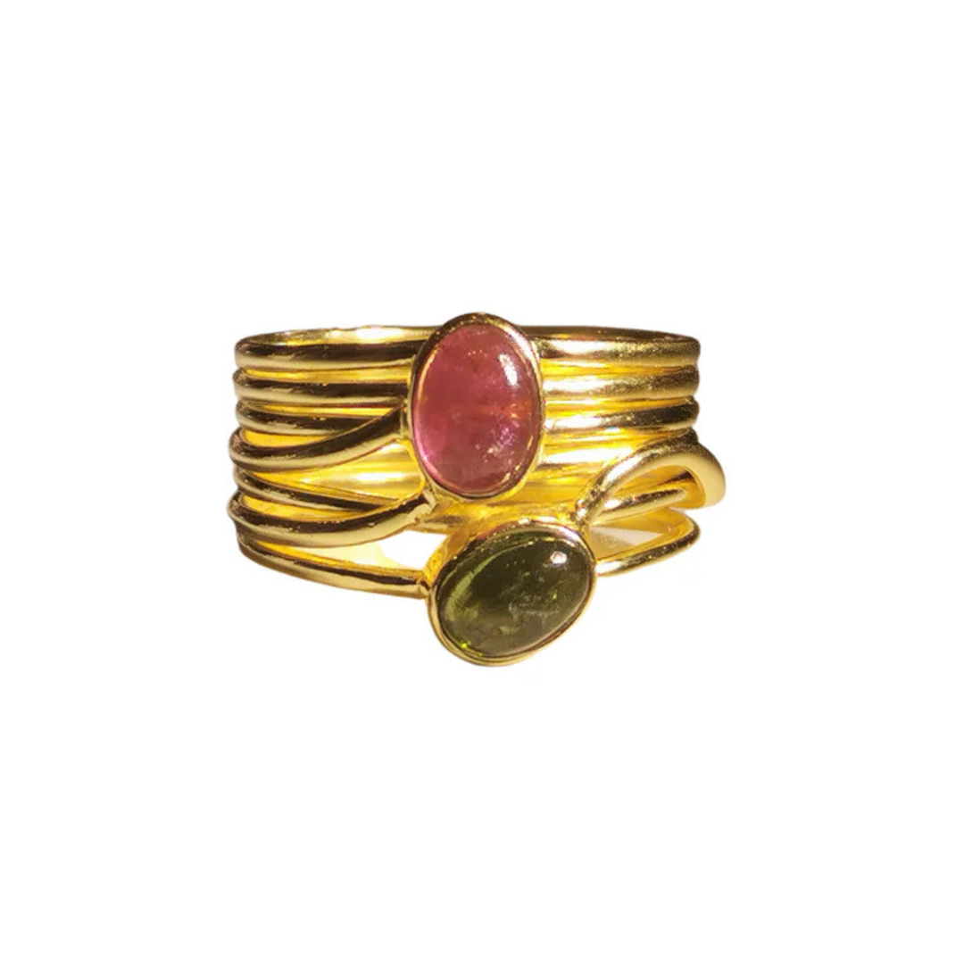 The Green and Pink Tourmaline in a Multi Band Gold Ring by Watermelon Tropical features two oval tourmaline gemstones: a red one at the top and a dark green one at the bottom. This piece of handmade jewellery has a modern, intertwined design.