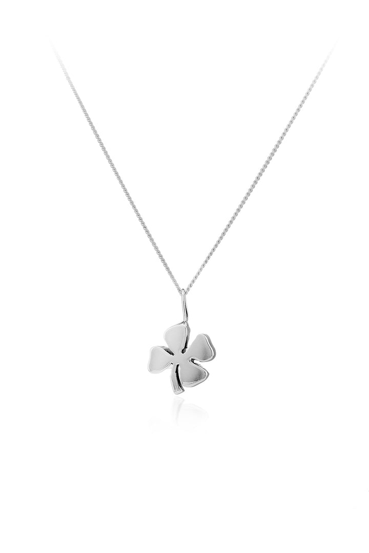 Adorned with the Lucky Four Leaf Clover Pendant from Cosmic Boulevard, this piece is a sterling silver necklace featuring a pendant shaped like a four-leaf clover. Handmade in a Dublin studio, the pendant boasts smooth, polished surfaces and hangs from an elegant, thin chain. The entire jewelry piece is beautifully set against a plain white background.