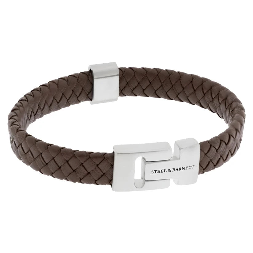 A braided brown Nappa leather bracelet with metallic clasp closures, featuring the engraved text "Steel and Barnett" on the clasp. The Harrison - Brown bracelet boasts a sophisticated, minimalist design and is presented on a neutral background, making it ideal for the modern professional.