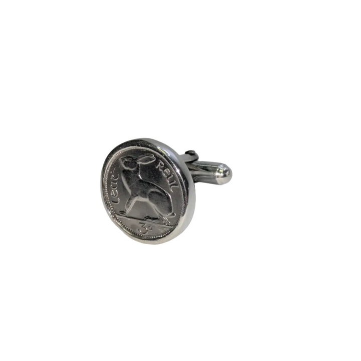Silver coin cufflinks on a light gray background
