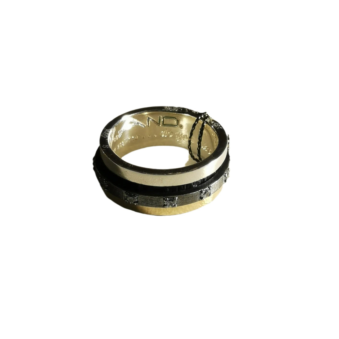 The K.And Spinner Ring in Silver & 18ct Yellow Gold with CZ features embedded square-cut cubic zirconia and engraved inner band, displayed on a white background.