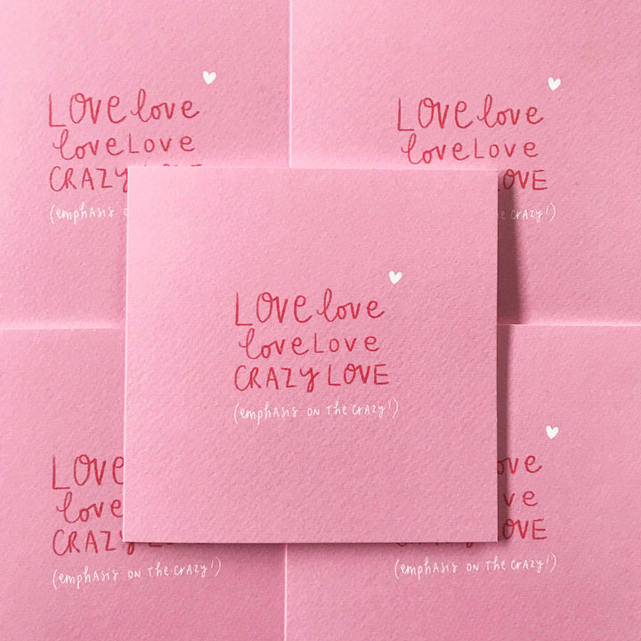 A Pickled Pompom LOVE LOVE LOVE LOVE CRAZY LOVE card, featuring an original illustration, is centered on a patterned background of similar cards. The textured card displays handwritten text in red and white: "LOVE love love love CRAZY LOVE (emphasis on the crazy)," with a small white heart above the text.