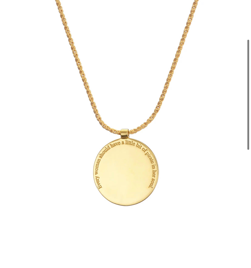 The Grace O'Malley Medallion Small by Jennifer Kinnear is a gold necklace featuring a rope chain and a round, flat pendant. The pendant has an inscription along the edge that reads, "Every woman should have a little bit of Paris in her heart." This exquisite piece, reminiscent of Queen Elizabeth I's medallions, adds timeless elegance to any outfit.