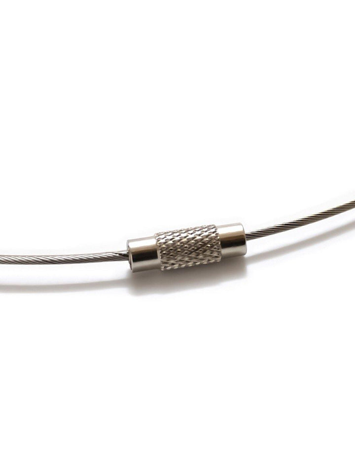 A close-up image of a Circle Pendant from Filip Vanas in various colors, featuring a thin stainless steel cable with a braided texture, showcasing the knurled cylindrical connector in the middle that is securely attached to the cable ends, set against a white background.