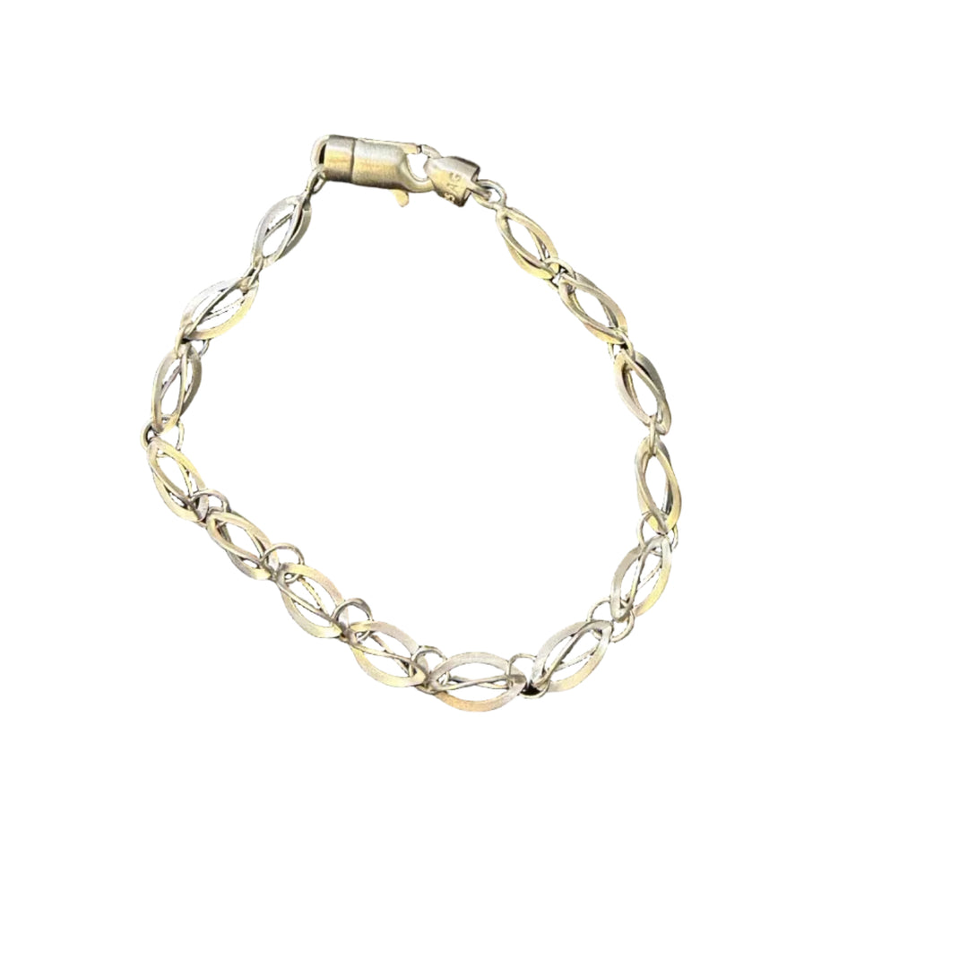 The Tezer Intertwined Oval Twist Link Bracelet features gracefully interlocking gold and silver oval shapes, secured with a lobster clasp and displayed on a white background—an elegant sterling silver accessory perfect for any occasion.
