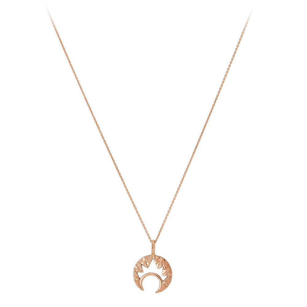 The "Moon & Moon" 9ct Gold Pendant by Cosmic Boulevard is a delicate necklace featuring a crescent moon pendant in both yellow and rose gold, adorned with a sunburst design on top. The thin, elegant chain enhances the unique and stylish pendant that combines celestial themes with intricate hand-engraved details.