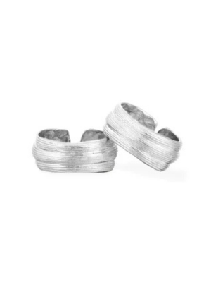 Two silver, textured Strata Rings by Inner Island, featuring adjustable cuffs with horizontal ridges, are displayed against a plain white background.