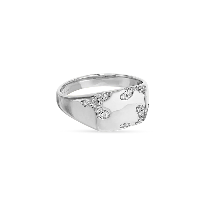 The Iced Signet Ring by Jane Koenig is crafted from 925 sterling silver with a polished finish and features sparkling gemstones in an abstract pattern, making it a striking, contemporary accessory.