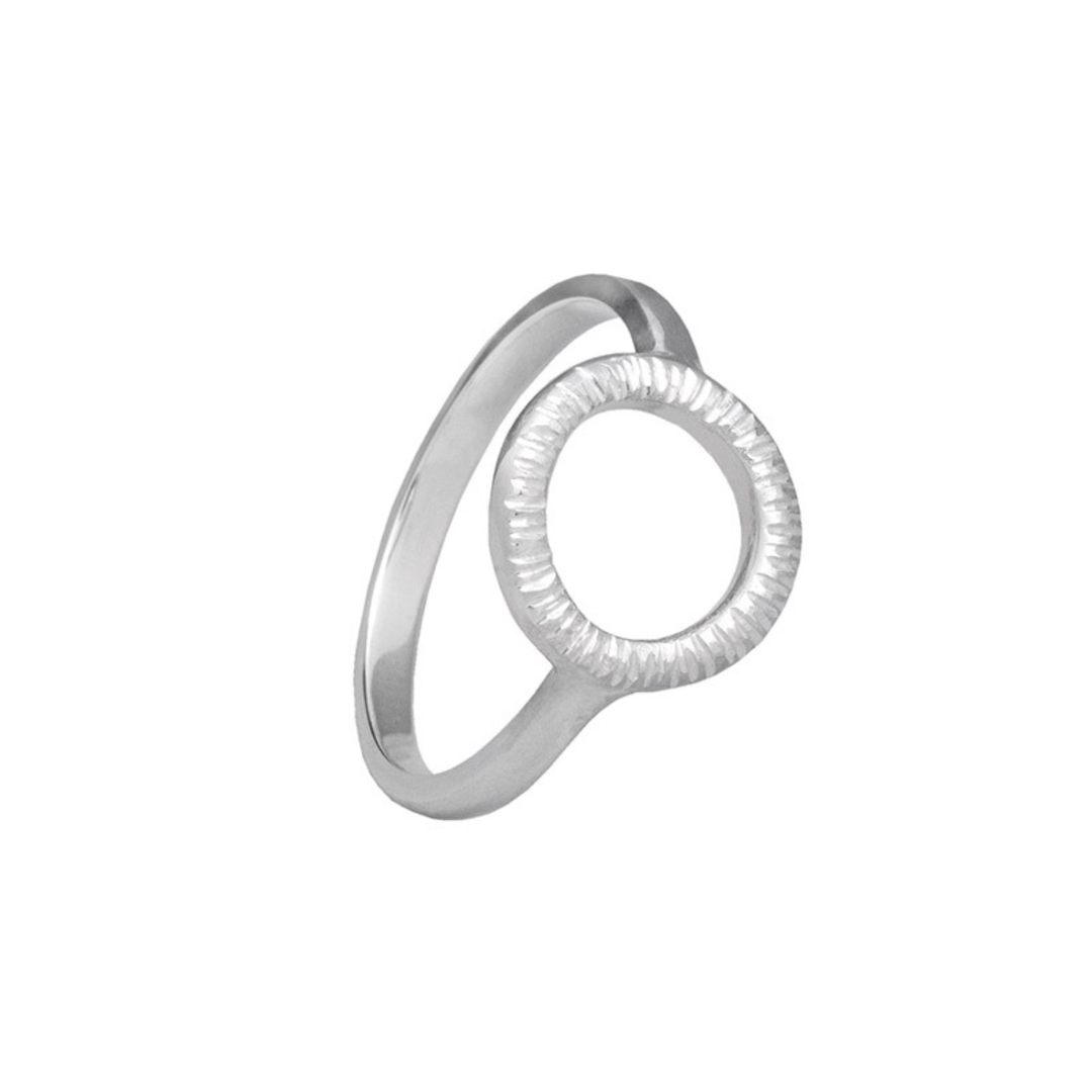 The Into The Light Mini Ring Silver by Aud is a minimalist sterling silver ring with a smooth band and an open circle top, hand-engraved for subtle texture along the inner edge.