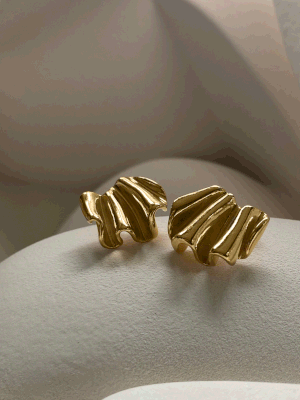 The Large Joy Earrings by Inner Island feature a wavy, organic shape and textured design, showcased against a soft background—perfect for anyone seeking unique, ethically crafted earrings.
