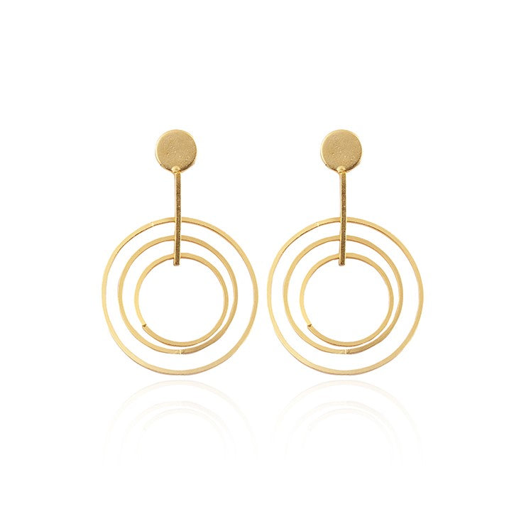 A pair of Kylie Gold Drop Circle Earrings with a geometric design featuring three concentric circles hanging from a small, round stud at the top. These sixties style dangling hoops from Watermelon tropical have a minimalist and modern appearance.