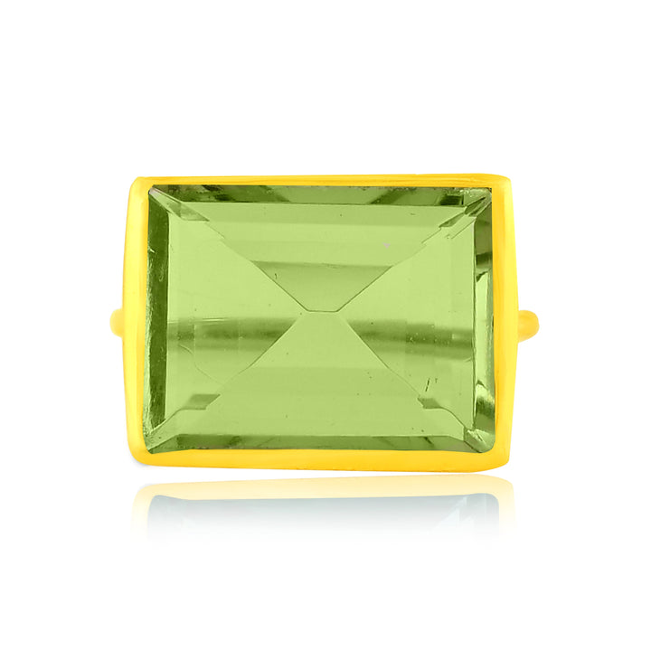 A 22 carat gold ring featuring a large, rectangular green gemstone with a faceted surface. The green stone is framed by a gold setting, making it an exquisite statement piece. The **Lenny Ring** by **Shyla** is shown on a white background with a light reflection beneath it.