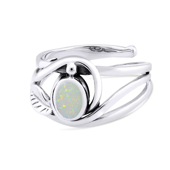 The Adjustable Leaf Ring by Gallardo & Blaine Designs features a silver band with a swirling design and an opalescent oval gemstone, showcasing vibrant greens, reds, and blues for a modern sophisticated look.