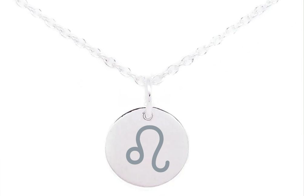 A Horoscope Large Disc Charm Silver by Personalised Charms. The chain is delicately twisted, and the pendant has a smooth, polished finish. The Leo zodiac sign stands out prominently in the center of the sterling silver charm.