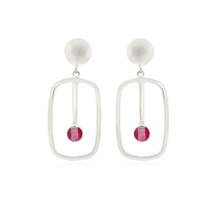 Introducing Gallardo & Blaine Designs' Lorelei Earrings Small: crafted in sterling silver, these elegant pieces feature a textured circular top leading into a sleek rectangular frame with a small pink gemstone enclosed at the base, providing a minimalist and modern allure.