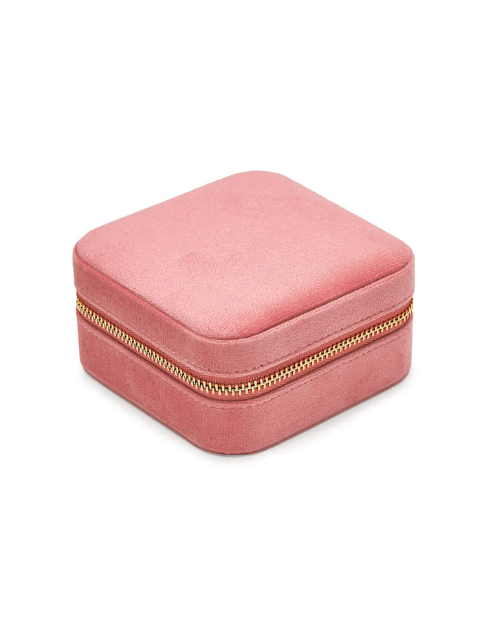 A small, square pink velvet jewellery box with a gold zipper closure, perfect for travel jewellery storage. The Luxurious Pink Velvet Travel Jewellery Box by SoCases has a smooth, soft texture and is closed, showing the zipper that runs along the edge. The background is plain white.