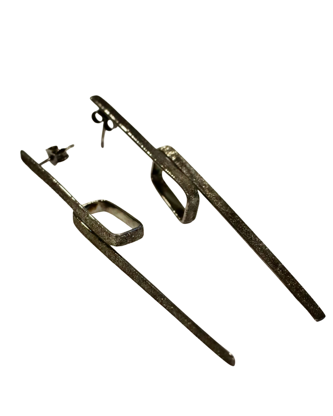 Theodora D's Lysithea Black Rhodium Silver Earrings are long, handcrafted geometric earrings with a textured finish and rectangular shapes in silver with black rhodium plating, made in Greece and shown on a white background.