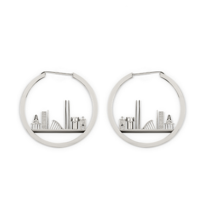 The Horizon of Dublin Hoops by Madeleine Sculptural Jewellery are silver hoop earrings with tiny books and bookshelf decor arranged inside each handcrafted, miniature bookshelf design.
