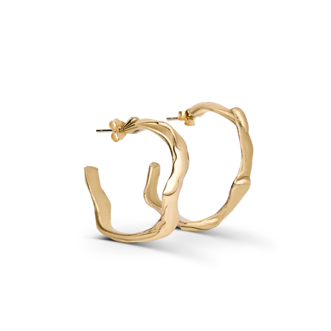 The Liana Hoops by Madeleine Sculptural Jewellery are 9ct gold earrings with an organic, wavy design, shown on a white background.