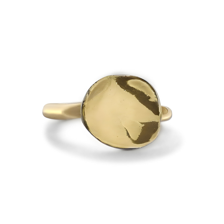 The Tide Ring by Madeleine Sculptural Jewellery features a round, slightly irregular hammered gold disc centerpiece, displayed from a top view against a white background.