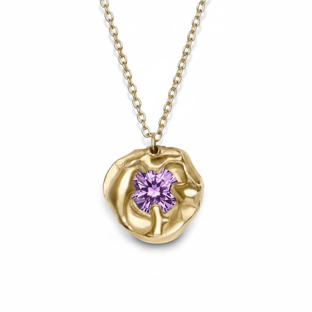 The Molten Necklace with Moissanite by Madeleine Sculptural Jewellery features a round, textured gold setting with a sparkling moissanite center on a simple gold chain—a striking piece shown against a white background.