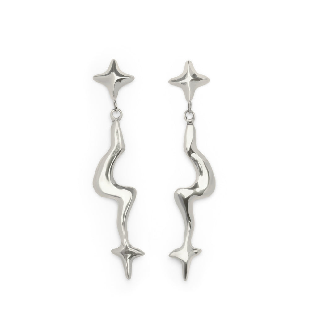 The Nova Earring Large by Madeleine Sculptural Jewellery features a pair of shiny, silver drop earrings with abstract, wavy stems and star-shaped motifs at both the top and bottom of each earring, displayed on a white background.