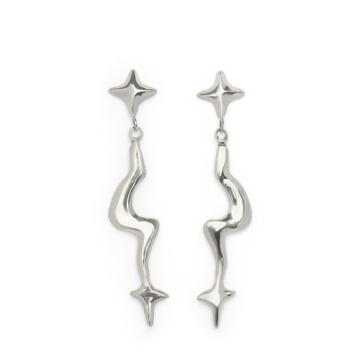 The Nova Earring Large by Madeleine Sculptural Jewellery features a pair of shiny, silver drop earrings with abstract, wavy stems and star-shaped motifs at both the top and bottom of each earring, displayed on a white background.