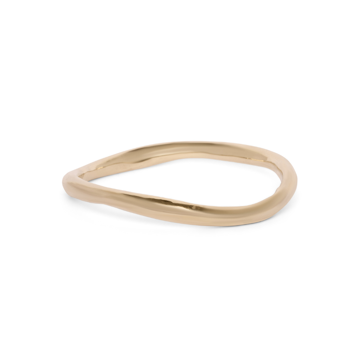 The Thorn Bangle by Madeleine Sculptural Jewellery, a slender and uniquely shaped gold piece, is showcased against a white background.