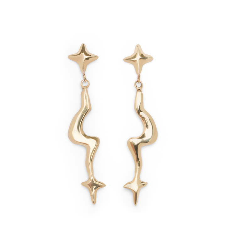 The Nova Earring Large from Madeleine Sculptural Jewellery features a shiny, polished gold finish and an abstract wavy design that connects small four-pointed stars at the top and bottom.