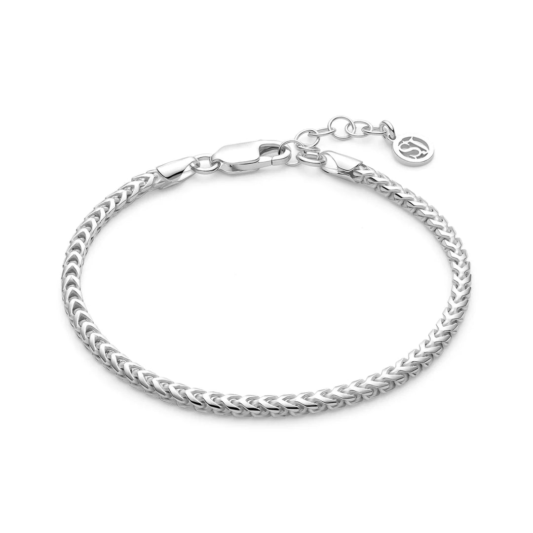 The Sif Jacobs Muro Bracelet Silver features a sleek woven sterling silver chain, adjustable extension, lobster clasp, and a delicate round charm—an elegant demi-fine jewellery piece for any occasion.