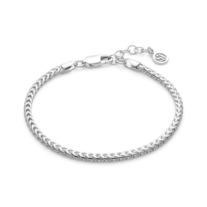 The Sif Jacobs Muro Bracelet Silver features a sleek woven sterling silver chain, adjustable extension, lobster clasp, and a delicate round charm—an elegant demi-fine jewellery piece for any occasion.