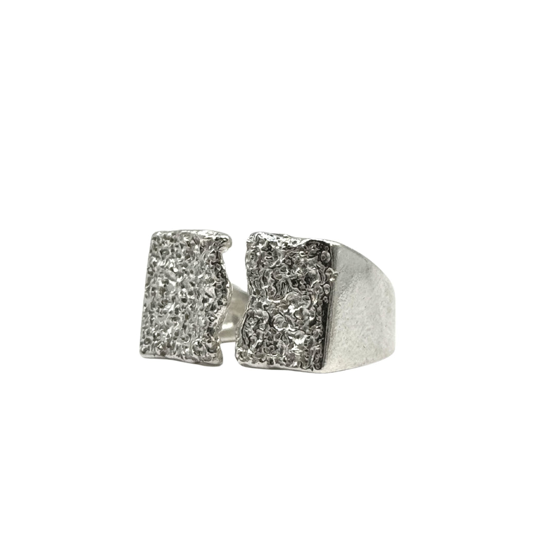 The Majesty Ring by Inó Jewellery is a handcrafted Dublin piece—a raw silver signet ring with a wide band and open front, finished with two textured rectangular ends for a bold, eye-catching look.