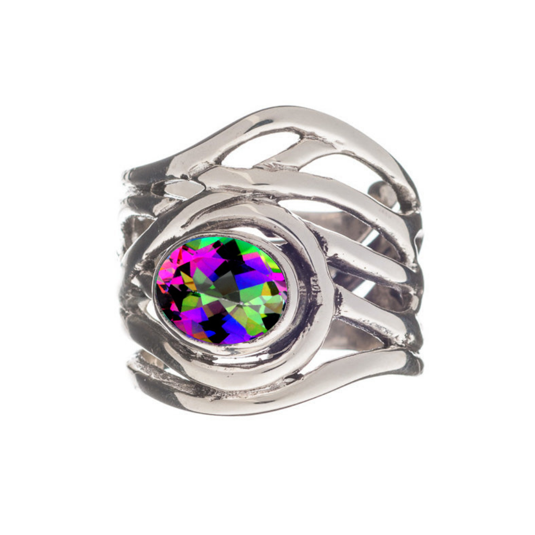 The Adjustable Mayhem Ring by Gallardo & Blaine Designs boasts a silver band with wavy, overlapping lines and a large oval gemstone. Its vibrant pink, green, and purple hues evoke an eye-catching medieval-inspired artistry.