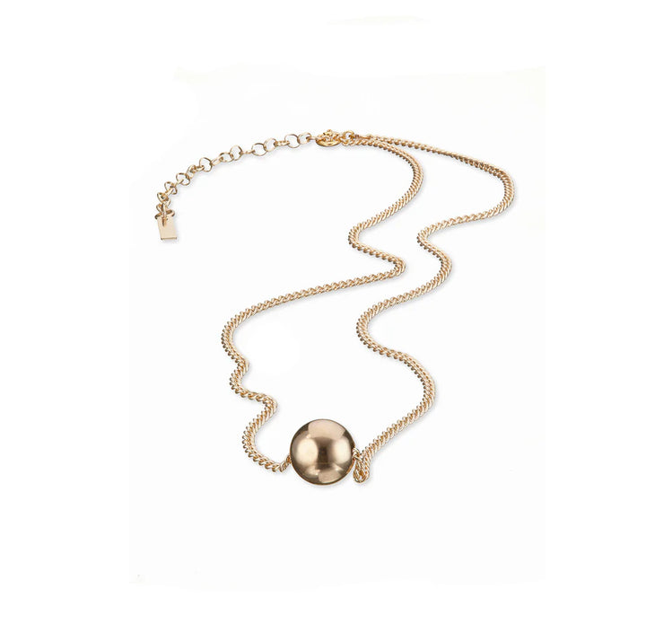 Gold necklace with a spherical pendant on a white background