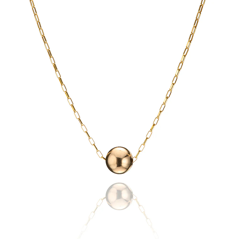 Gold necklace with a round pendant on a white background