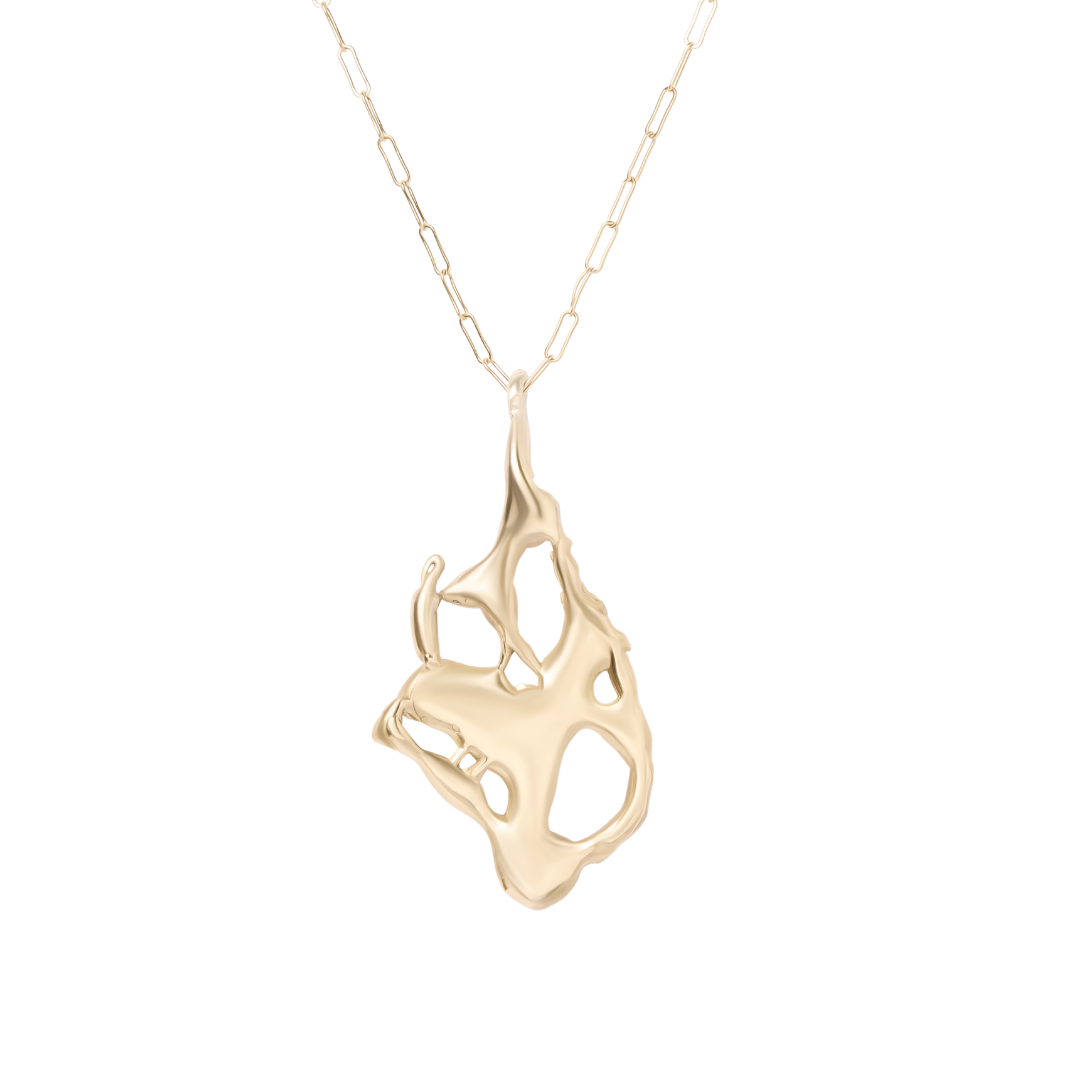 The Molten Necklace by Madeleine Sculptural Jewellery features a fine gold-tone chain and an abstract, organic-shaped pendant with smooth edges and open spaces, crafted from recycled brass for a unique, sustainable look.