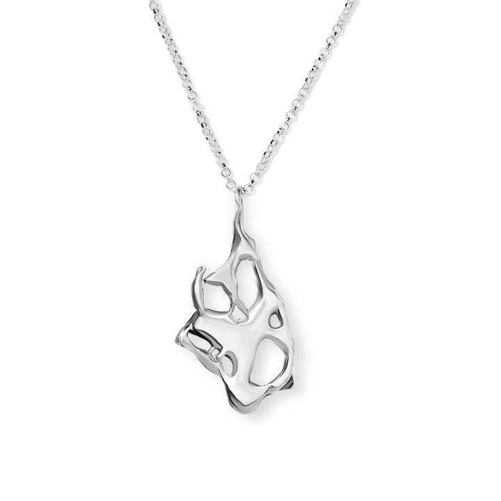 The Molten Necklace by Madeleine Sculptural Jewellery is a silver piece with an abstract, hand-carved pendant featuring open cut-outs, suspended from a delicate chain for a unique look.