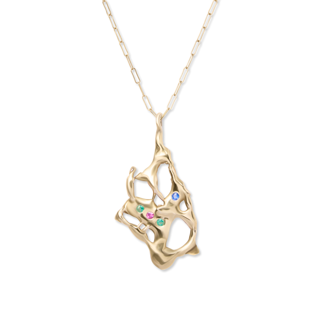 The Molten Pendant with Gemstones by Madeleine Sculptural Jewellery features a unique gold pendant with organic openwork shapes and green, blue, and pink gemstones on a delicate, elongated chain. This handmade piece highlights true artistry.