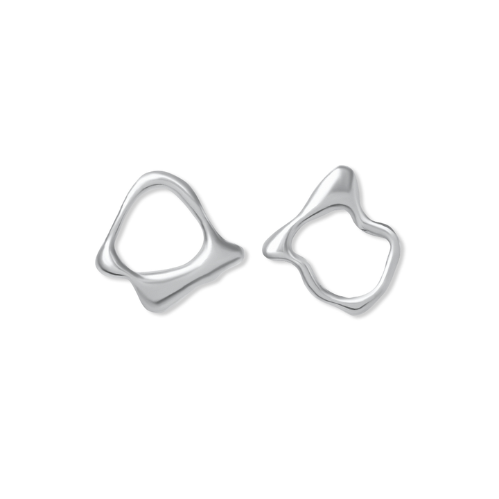 The Asymmetrical Molten Studs by Madeleine Sculptural Jewellery feature unique, abstract silver shapes with smooth, wavy edges, showcasing handmade artistry and organic elegance against a white background.