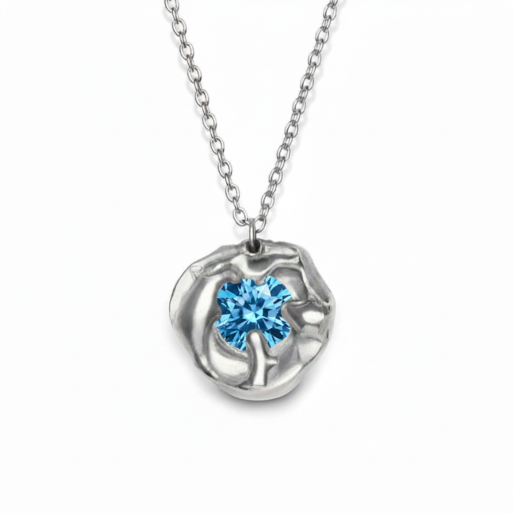 The Molten Necklace with Moissanite by Madeleine Sculptural Jewellery is a handmade silver piece featuring an organic-shaped pendant set with a brilliant moissanite gemstone—an elegant example of sustainable jewelry design.