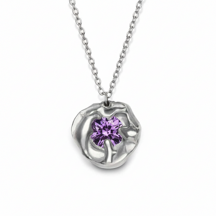 The Molten Necklace with Moissanite by Madeleine Sculptural Jewellery features an abstract silver setting with a brilliant round moissanite at its center, suspended on a delicate chain—a unique piece of handmade jewellery.