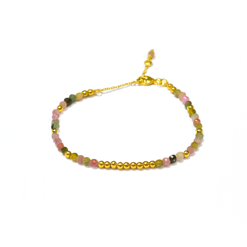 The Watermelon Tropical Multi Tourmaline Gold Bracelet features delicate gold plating, small gold beads, and multicolored tourmaline gemstones in pink, green, and beige with an adjustable gold chain clasp, shown on a white background.