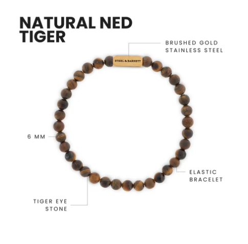 The Natural Ned 6mm Round Gemstone Bracelet by Steel and Barnett features matte tiger eye beads on an elastic band with a gold stainless steel accent engraved "STEEL & BARNETT." Diagram labels note materials and key features.
