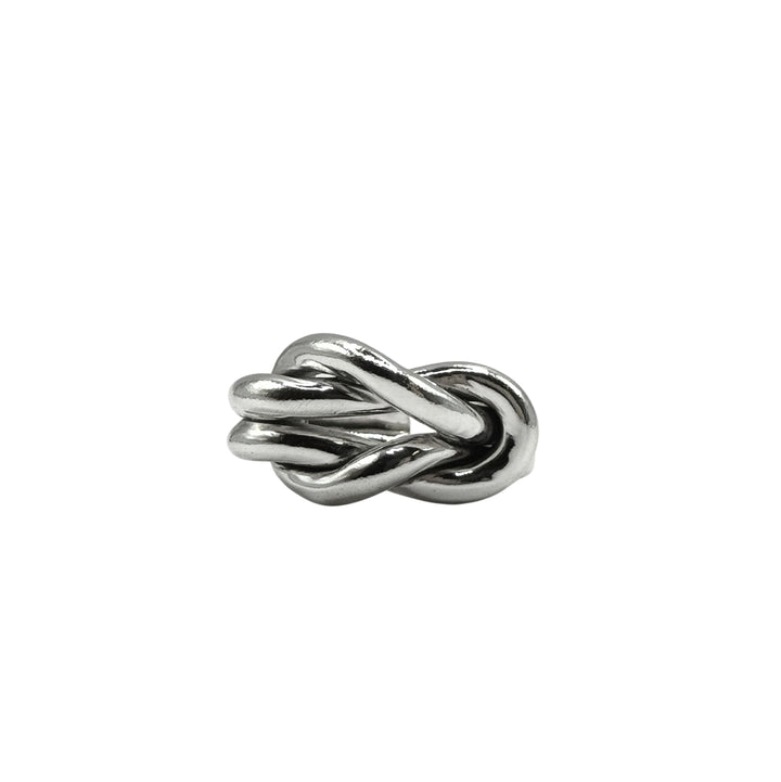 The Nautical Knot Ring by Inó Jewellery, a chunky, handcrafted silver piece shaped like intertwined loops, is displayed against a plain white background.