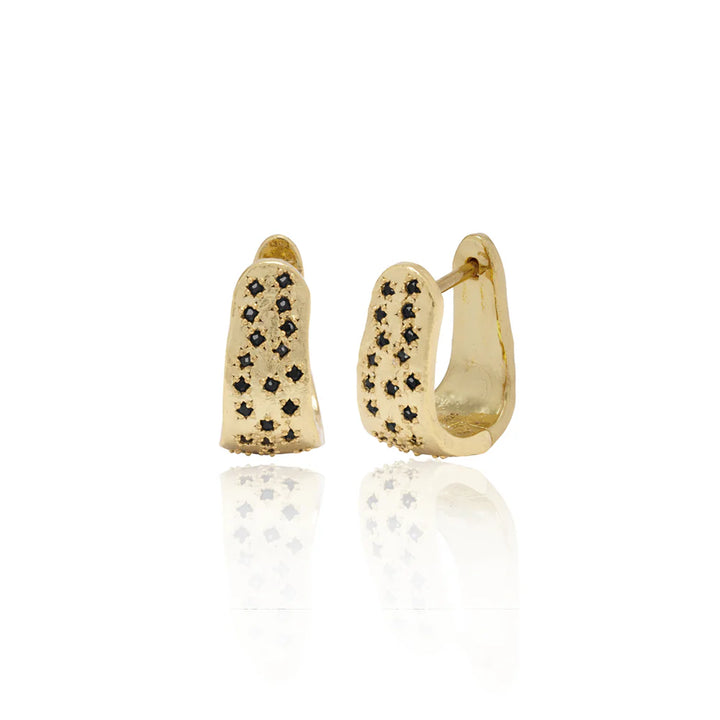 Gold wide hoop style earrings with black gemstones on a white background