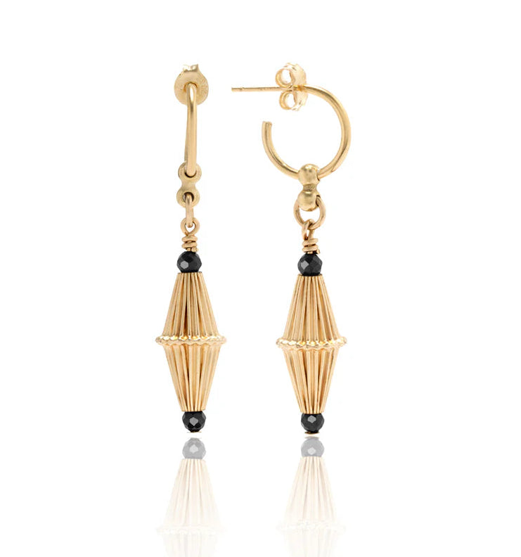 Scribble & Stone’s Nightsky Cylinder Earrings feature 14ct gold fill hoops with elongated, ribbed cone pendants accented by small black beads at each end—unique gold earrings for standout style.